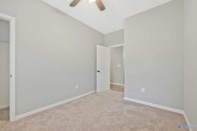 empty room featuring light colored carpet and ceiling fan