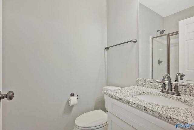 bathroom featuring vanity, toilet, and an enclosed shower