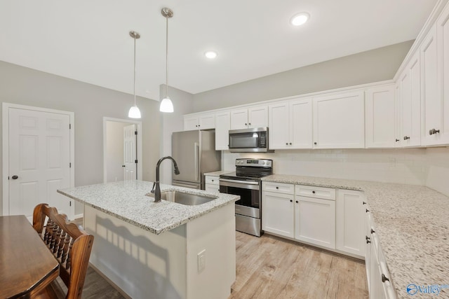 kitchen with appliances with stainless steel finishes, white cabinetry, and sink