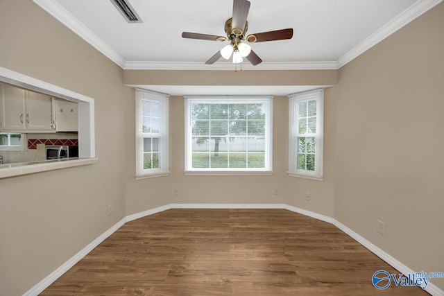 unfurnished dining area with ornamental molding, hardwood / wood-style floors, and ceiling fan