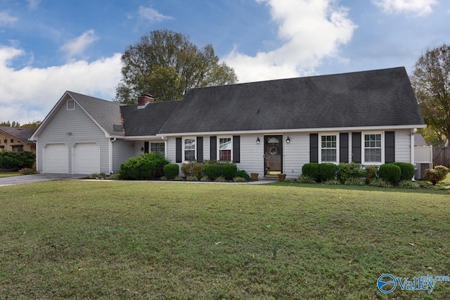 view of front of house with a garage, central air condition unit, and a front lawn