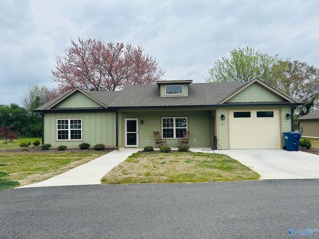 view of front of property featuring a garage and a front lawn