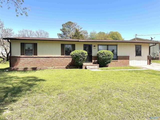 ranch-style home with a front yard and brick siding