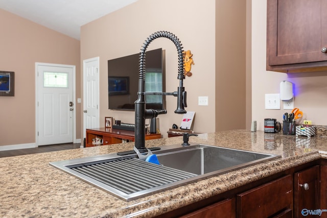 7110 New Bethel Rd, Hokes Bluff, AL 35903 - kitchen featuring a sink, wood finished floors, dark brown cabinetry, and baseboards
