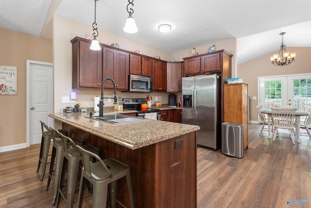 7110 New Bethel Rd, Hokes Bluff, AL 35903 - kitchen with stainless steel appliances, a peninsula, dark wood-style floors, baseboards, and a chandelier