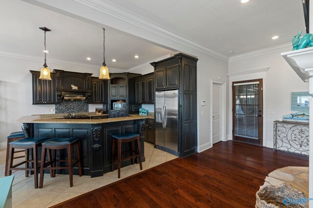 kitchen with crown molding, light hardwood / wood-style flooring, stainless steel appliances, light stone countertops, and dark brown cabinetry