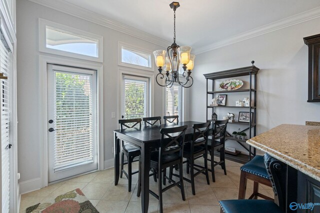 tiled dining room featuring a notable chandelier and ornamental molding