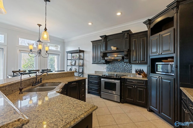 kitchen with light tile patterned flooring, stainless steel appliances, pendant lighting, sink, and backsplash