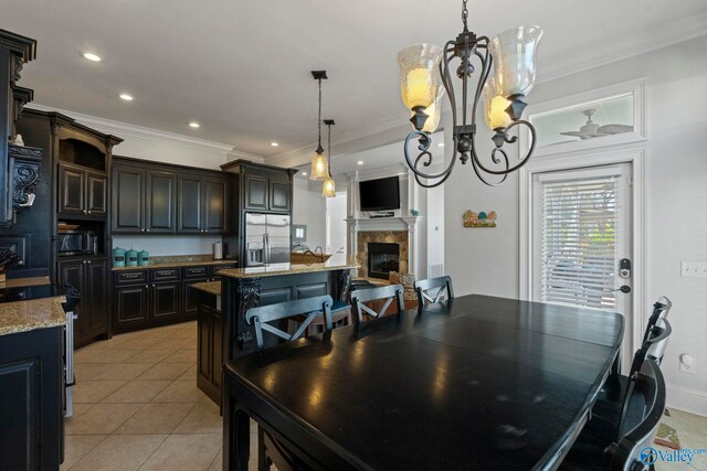 tiled dining space with crown molding and ceiling fan with notable chandelier