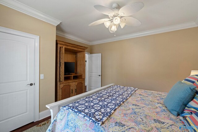 bedroom featuring hardwood / wood-style floors, ornamental molding, and ceiling fan