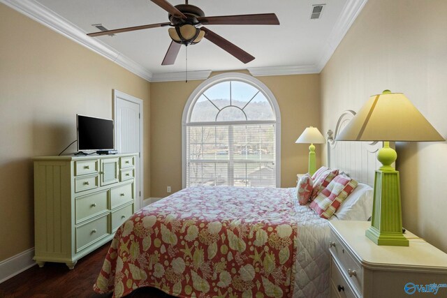 bedroom featuring ceiling fan, dark hardwood / wood-style flooring, and ornamental molding