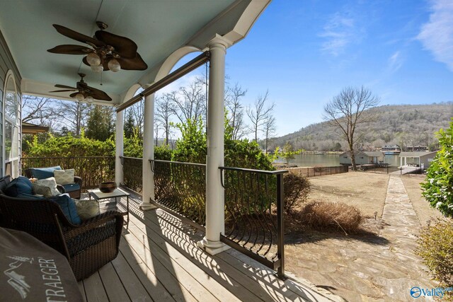 deck featuring a mountain view, ceiling fan, and outdoor lounge area