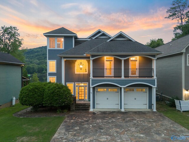 view of front of property with a balcony and a garage