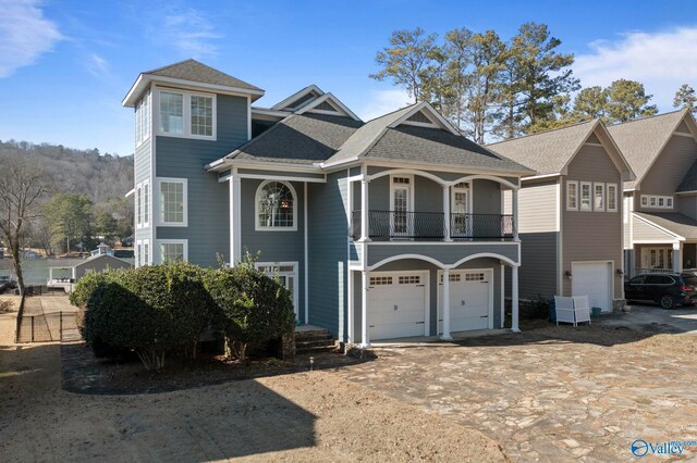 view of front of house featuring a balcony and a garage