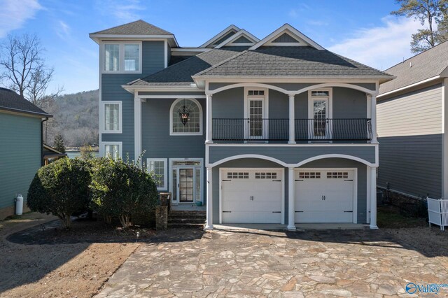 view of front of home featuring a balcony and a garage