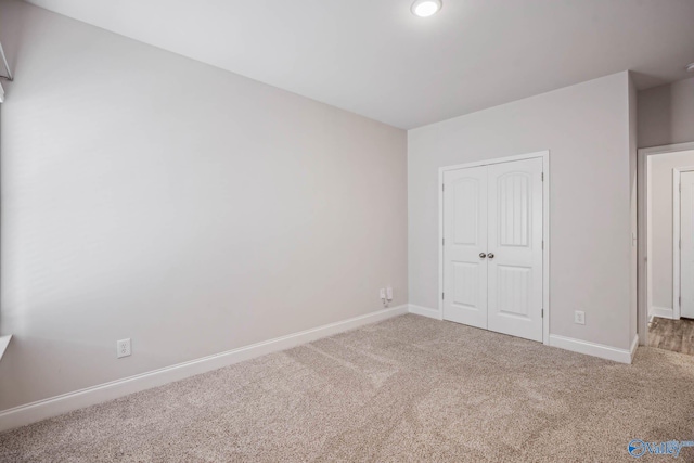 unfurnished bedroom featuring carpet floors and a closet