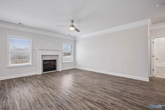 unfurnished living room featuring crown molding, ceiling fan, and dark hardwood / wood-style floors