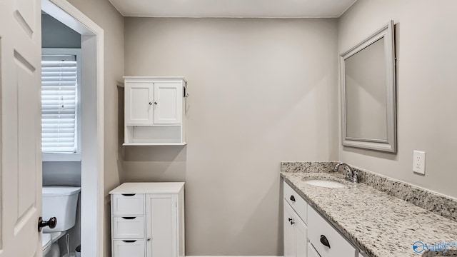 bathroom with vanity and toilet