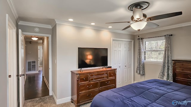 carpeted bedroom featuring a closet, crown molding, and ceiling fan