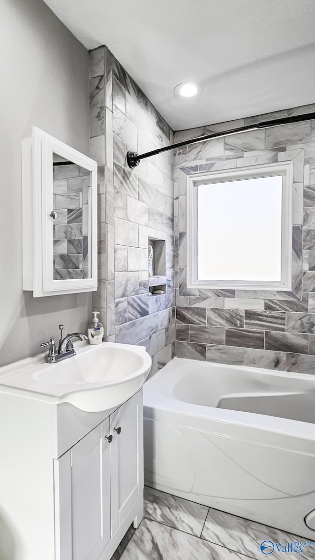 bathroom featuring vanity and tiled shower / bath combo