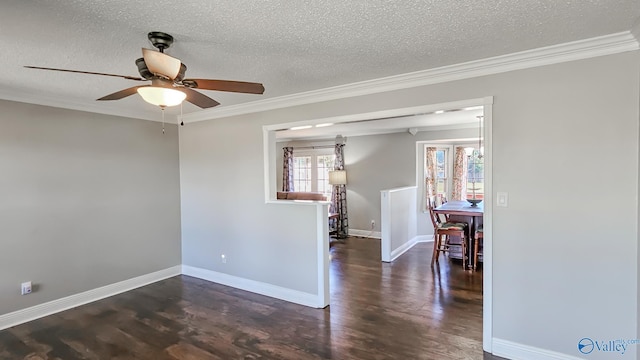 empty room featuring ornamental molding, a textured ceiling, and dark wood-type flooring