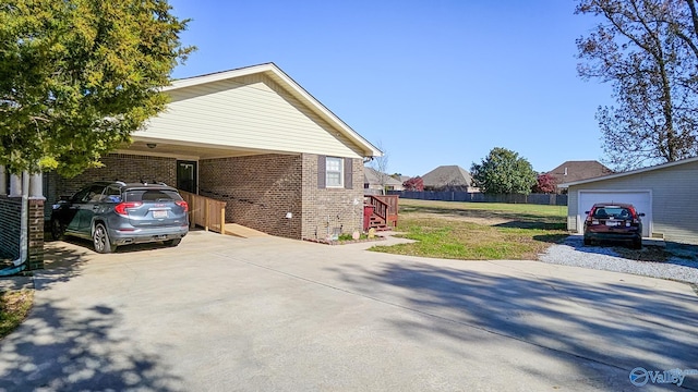 view of home's exterior with a carport and a lawn