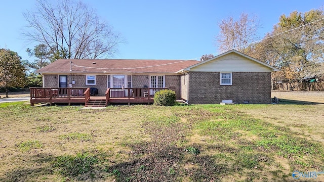 rear view of house with a yard and a deck