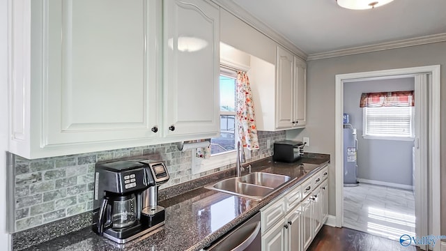 kitchen featuring dark hardwood / wood-style flooring, white cabinetry, sink, and a healthy amount of sunlight