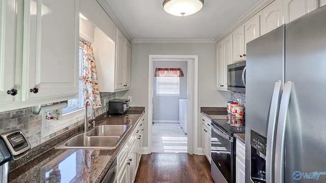 kitchen featuring backsplash, white cabinets, sink, dark hardwood / wood-style flooring, and stainless steel appliances