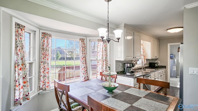 dining space featuring a notable chandelier, ornamental molding, sink, and dark wood-type flooring