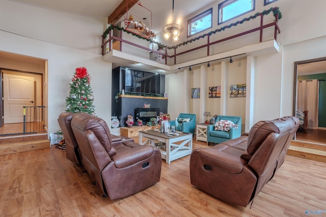 living room featuring wood-type flooring and a towering ceiling