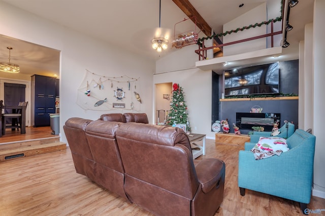 living room featuring ceiling fan, beamed ceiling, high vaulted ceiling, and hardwood / wood-style flooring