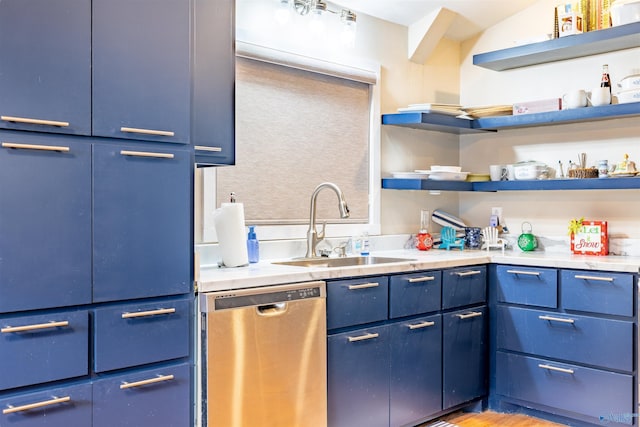 kitchen with dishwasher, sink, light wood-type flooring, and blue cabinetry