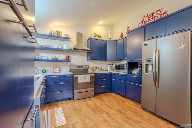 kitchen featuring blue cabinetry, light hardwood / wood-style flooring, wall chimney exhaust hood, and appliances with stainless steel finishes