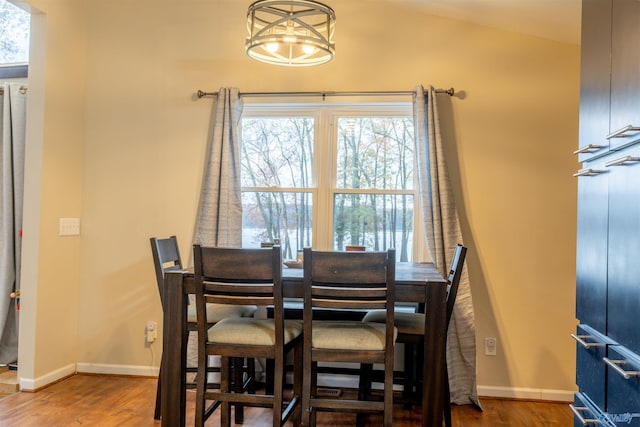 dining area with hardwood / wood-style flooring and lofted ceiling
