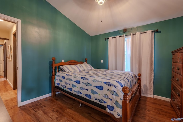 bedroom featuring hardwood / wood-style flooring, ceiling fan, and lofted ceiling