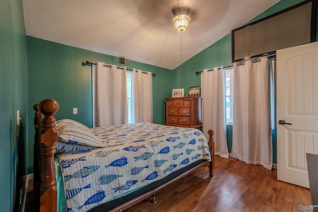 bedroom with hardwood / wood-style floors, vaulted ceiling, and ceiling fan