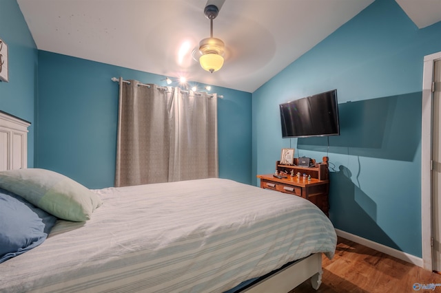 bedroom with hardwood / wood-style flooring, ceiling fan, and lofted ceiling
