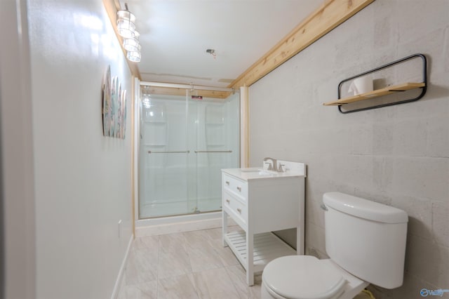 bathroom featuring a shower with door, vanity, and toilet