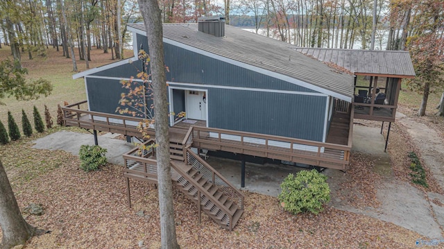 back of property with a deck and a sunroom