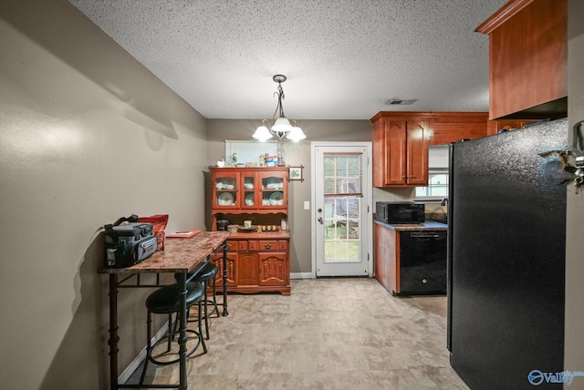 1004 Carter Grove Rd, Hazel Green, AL 35750 - kitchen with black appliances, a textured ceiling, brown cabinets, and baseboards