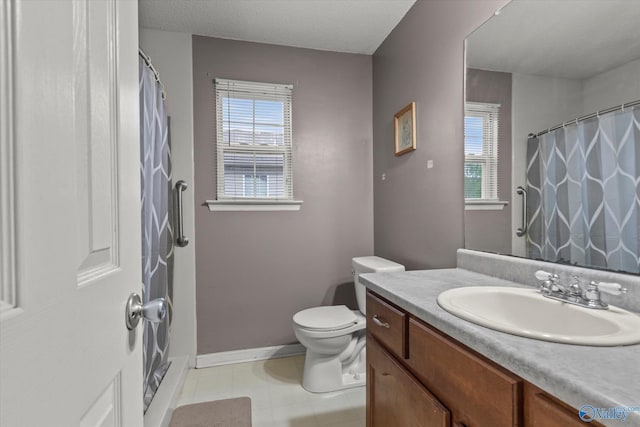 1004 Carter Grove Rd, Hazel Green, AL 35750 - bathroom featuring toilet, plenty of natural light, vanity, and baseboards