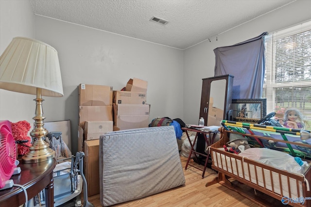 1004 Carter Grove Rd, Hazel Green, AL 35750 - bedroom with wood finished floors, visible vents, and a textured ceiling