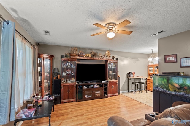 1004 Carter Grove Rd, Hazel Green, AL 35750 - living area featuring a textured ceiling, ceiling fan, wood finished floors, and visible vents