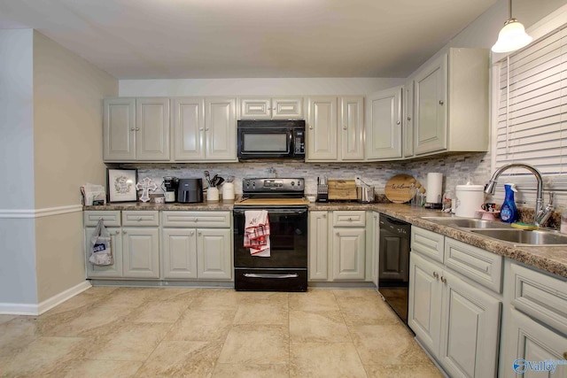 kitchen featuring black appliances, decorative backsplash, pendant lighting, and sink