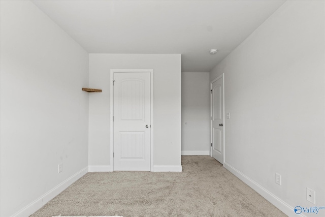 unfurnished bedroom featuring light colored carpet