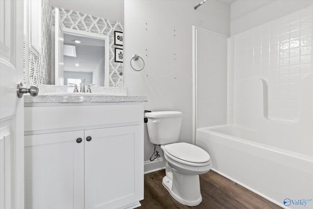 full bathroom with vanity, toilet, shower / bath combination, and hardwood / wood-style flooring