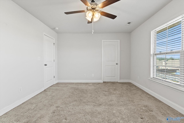 empty room featuring carpet flooring and ceiling fan