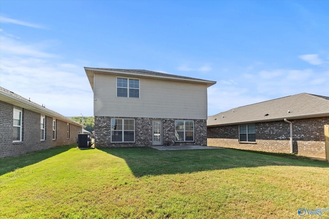 rear view of property with central AC and a yard