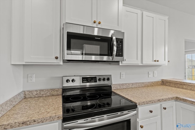 kitchen featuring white cabinets and appliances with stainless steel finishes